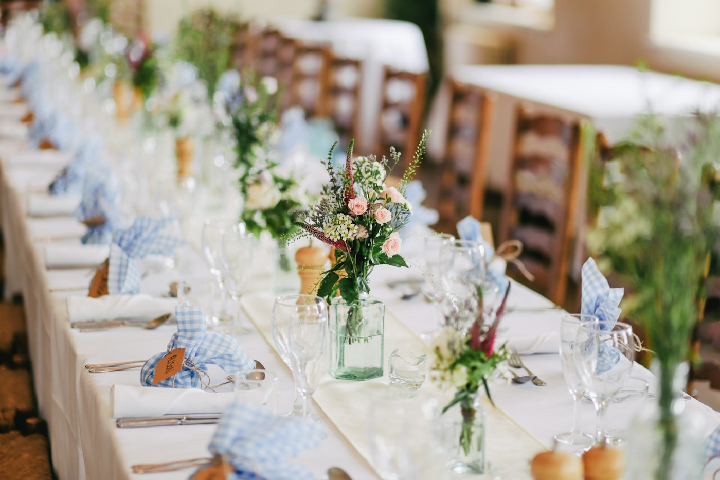 A table arranged with plates and glassware